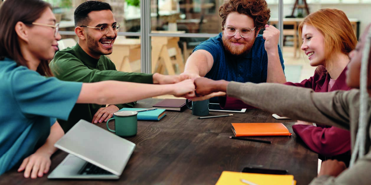 group-of-students-joining-hands-in-the-center